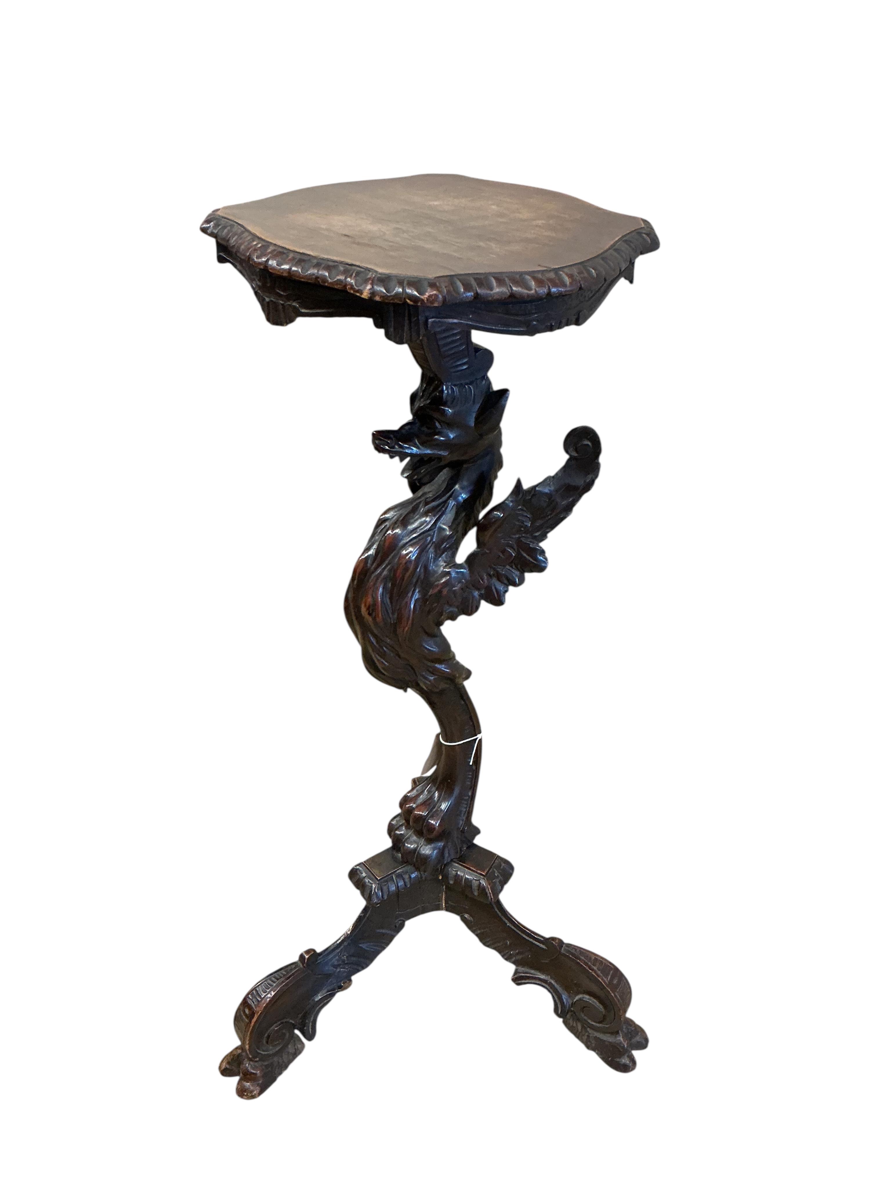 A 19th century Italian carved walnut griffin torchere, height 92cm